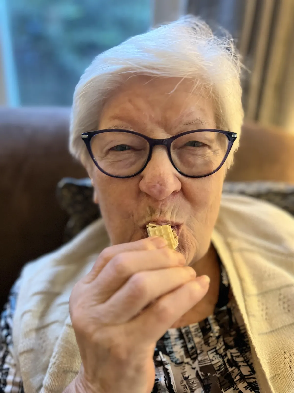 Nonna Maria enjoying a Toroon, the Italian nougat wafer made from her family recipe